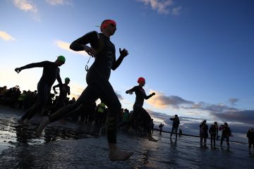 Competitors enter the ocean for the start of the swim. (Photo by Sean M. Haffey/Getty Images)